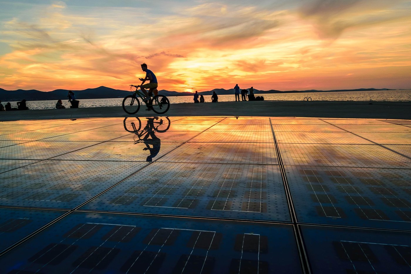 Radfahrer auf dem Sonnengruß in Zadar bei Sonnenuntergang